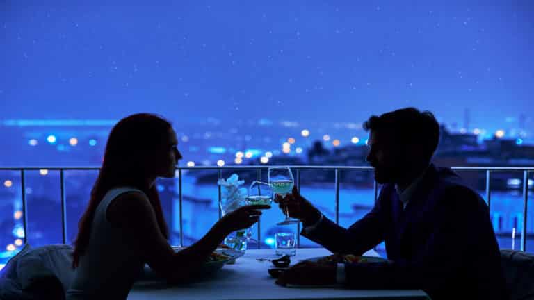 Paar dat van romantisch diner bij restaurant geniet